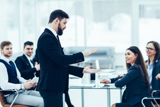 senior Manager of the company holds a working meeting with business team in modern office. the photo has a empty space for your text.