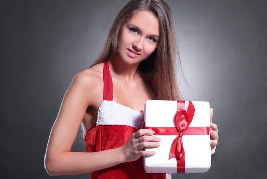 stylish young woman in costume of Santa Claus with Christmas gift . isolated on a black background.