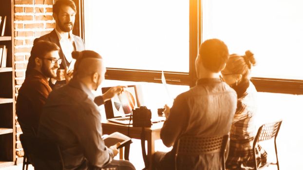 group of designers discussing a new color palette in the workplace in a modern office. the photo has a empty space for your text