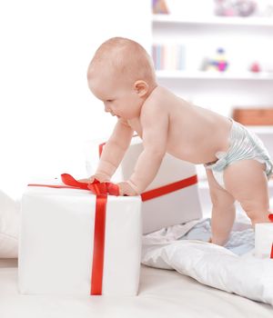 pretty baby plays with gift boxes .photo with copy space