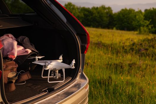drone ready for fly in suv trunk landscape nature mountains sunset