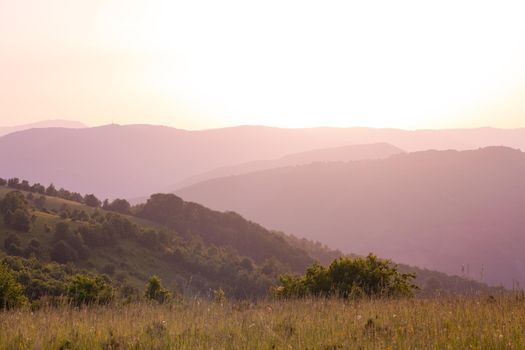 landscape of  summer nature in sunset in mountains and hills on countryside abstract lines and curves background