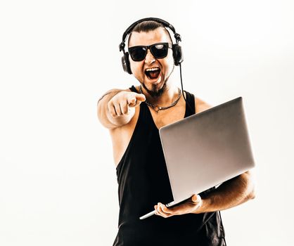 charismatic DJ - rapper in headphones and with a laptop .photo on a white background and has an empty space for your text