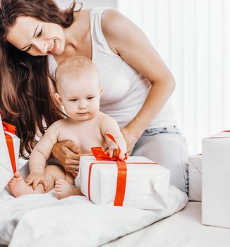 happy mothers her year-old baby consider the box with the shopping purchased for the holiday