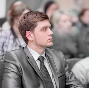 young entrepreneurs listen to the lecture, sitting in the hall of the business center . business and education