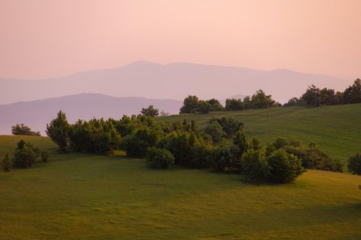 landscape of  summer nature in sunset in mountains and hills on countryside abstract lines and curves background