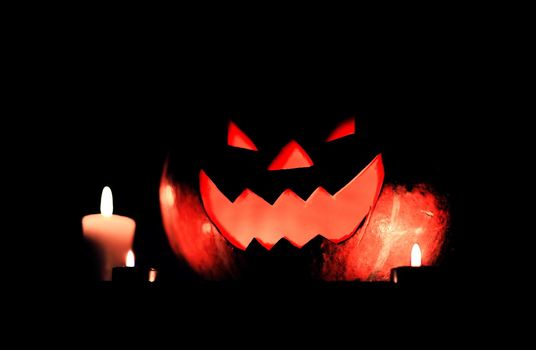 candles and pumpkin for Halloween on dark background.photo with copy space