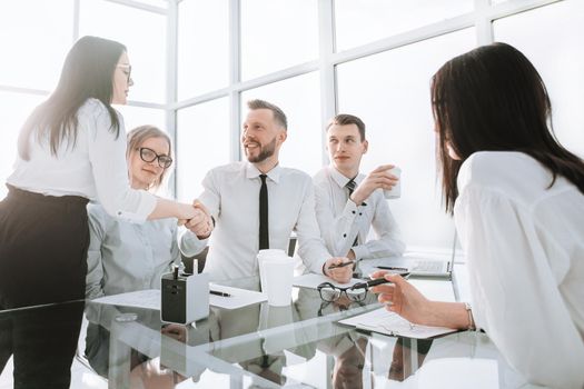 welcome handshake employees near the desktop in the office. office weekdays