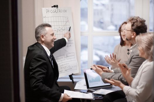 adult businessman showing business partners results of a successful project.success in business