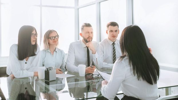 background image of a group of business people sitting at a Desk. photo with copy space