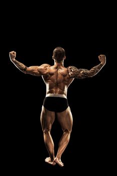 bodybuilder posing. Beautiful sporty guy male power. Fitness muscular body.