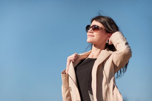 portrait of a young successful woman against the sky . photo with copy space