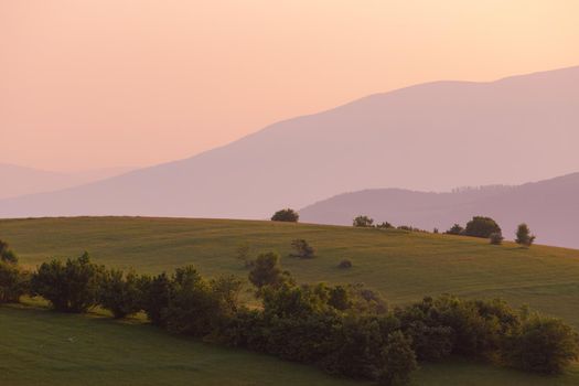 landscape of  summer nature in sunset in mountains and hills on countryside abstract lines and curves background