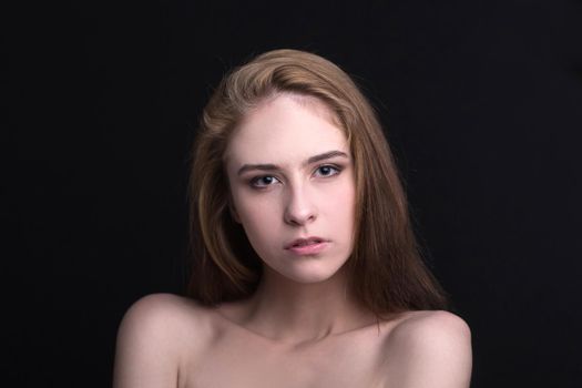 close up. portrait of a confident young woman. isolated on black