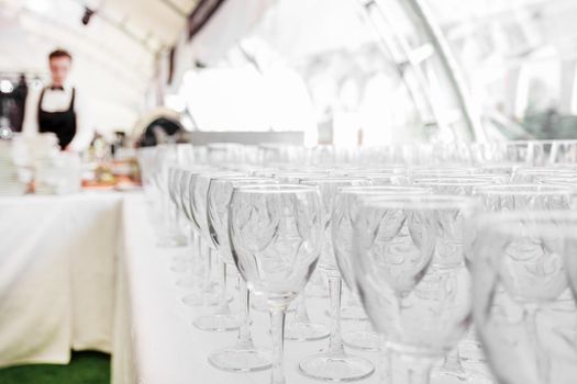 empty glass glasses on the table in the restaurant . festive reception