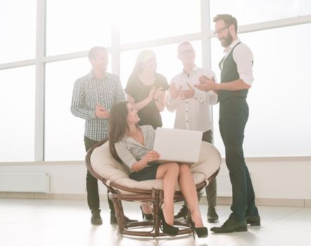 business woman and her business team are at the workplace in the office. people and technology