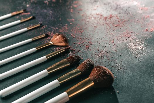 nine professional makeup brushes on a black background.photo with copy space