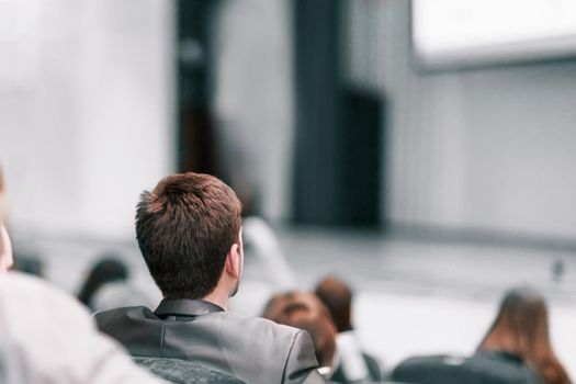 audience in the hall of the business center . business and education