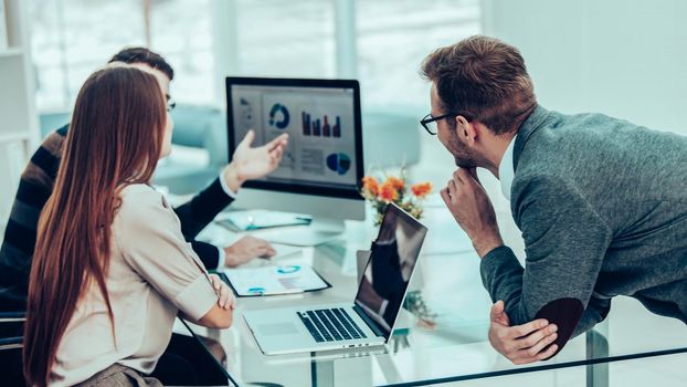 specialist in Finance and professional business team doing analysis of marketing reports, in a modern office