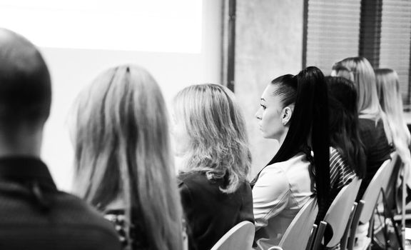 rear view.the listeners sitting in the conference room.close up.