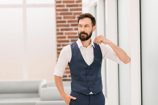 modern businessman standing in a bright office. photo with copy space