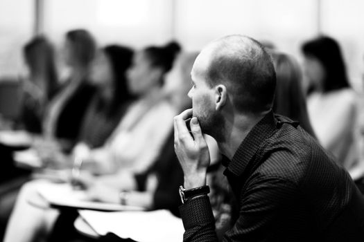 close up.serious businessman on blurred background of the conference hall