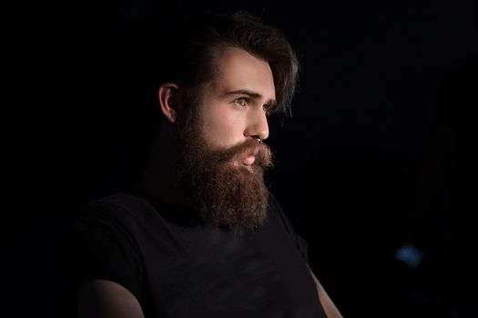 rear view. bearded serious man sitting in a chair