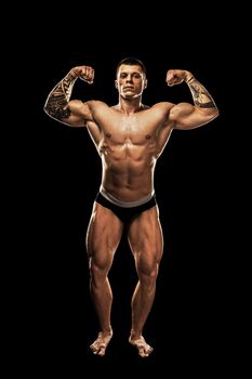 bodybuilder posing. Beautiful sporty guy male power. Fitness muscular body.