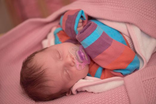 One month newborn baby in bed. Close up portrait of sleeping cute little girl