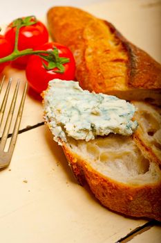 fresh blue cheese spread ove french baguette with cherry tomatoes on side