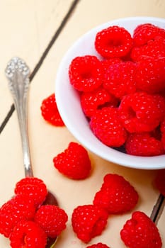 bunch of fresh raspberry on a bowl and white wood rustic  table