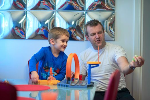 Father and children playing kids stunt racing toy car game