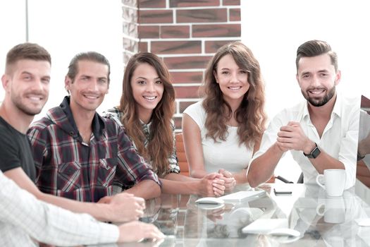 portrait of a successful creative team, sitting behind a Desk