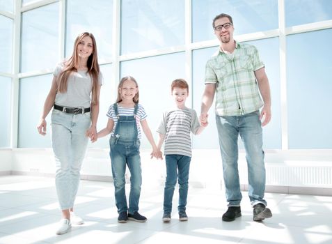 parents with small children standing in the new house .photo with copy space