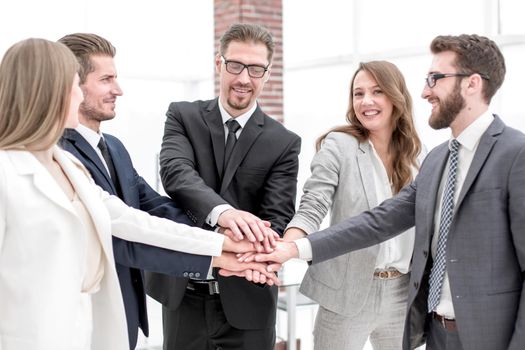 successful business team putting their palms together.the concept of teamwork