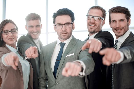 Portrait of excited young business people pointing at you