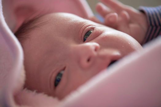 One month newborn baby in bed. Close up portrait of sleeping cute little girl