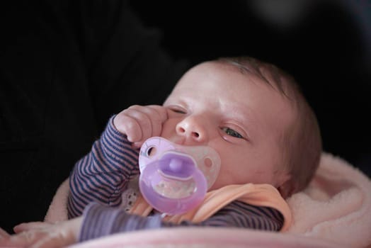 One month newborn baby in bed. Close up portrait of sleeping cute little girl