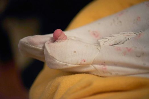 One month newborn baby in bed. Close up portrait of sleeping cute little girl