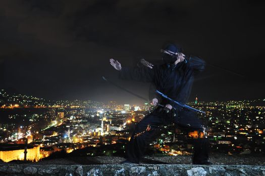 ninja assasin hold katana samurai old martial weapon swordat night with city lights in background