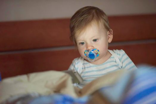 cute  little baby playing while making first steps and learnig to walk at home