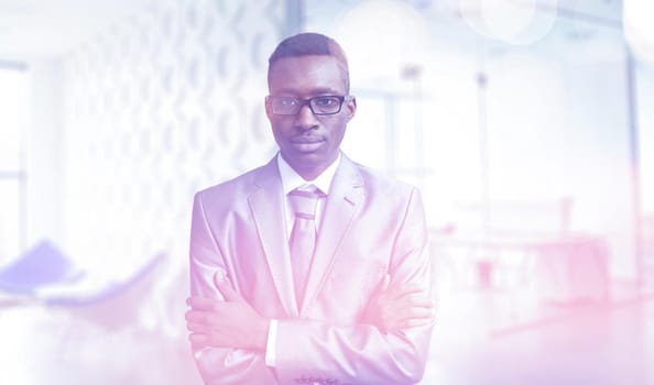 Portrait of young junior businessman in front of his big modern office