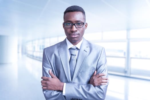 Portrait of young junior businessman in front of his big modern office