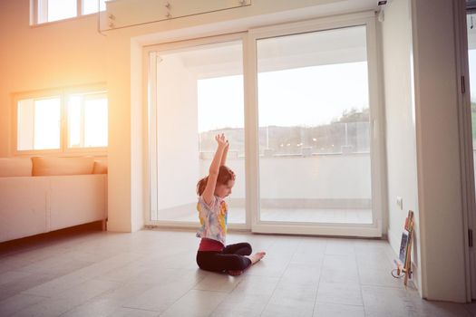 Little girl have online training over  tablet and doing modern ballet dance exercise at home. Online education concept class in modern ballet school. Social distance during quarantine, self-isolation in coronavirus