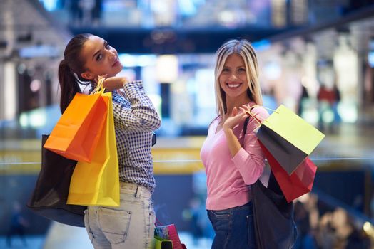 happy young girls in  shopping mall, friends having fun together