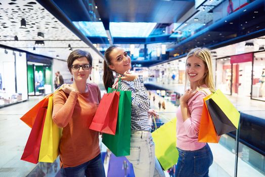 happy young girls in  shopping mall, friends having fun together