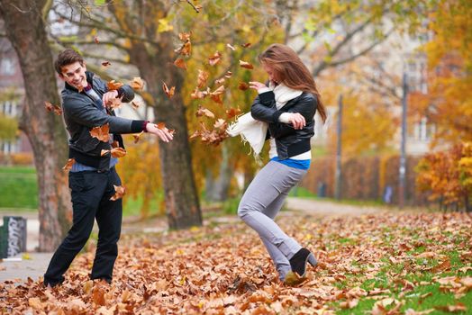 romantic young couple have fun in city park at autumn season