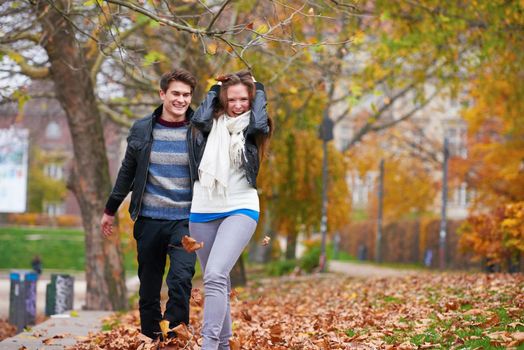 romantic young couple have fun in city park at autumn season