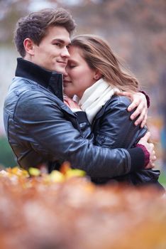 romantic young couple have fun in city park at autumn season