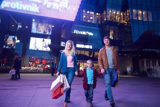 Group Of Friends Enjoying Shopping Trip Together
group of happy young frineds enjoying shopping night and walking on steet on night in with mall in background